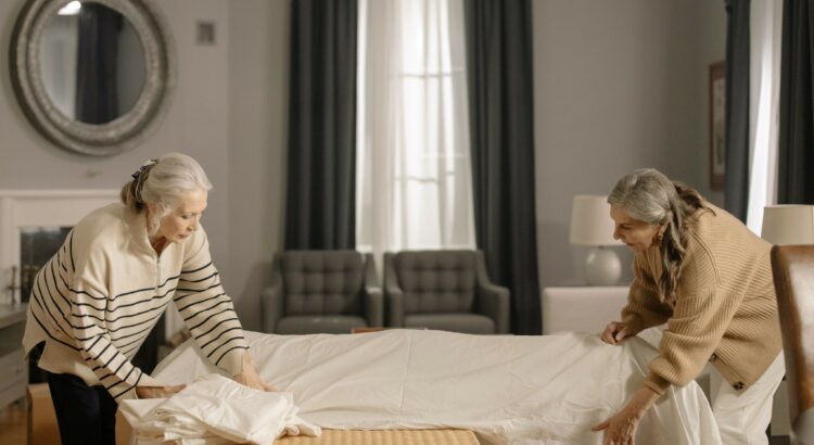 seniors covering furniture for house move